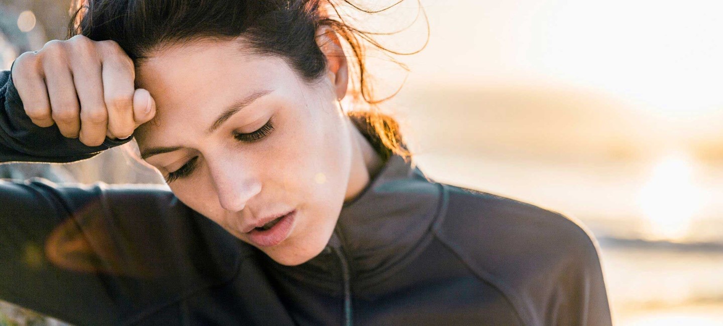covid2320x1000.jpg A woman resting her head in her hand