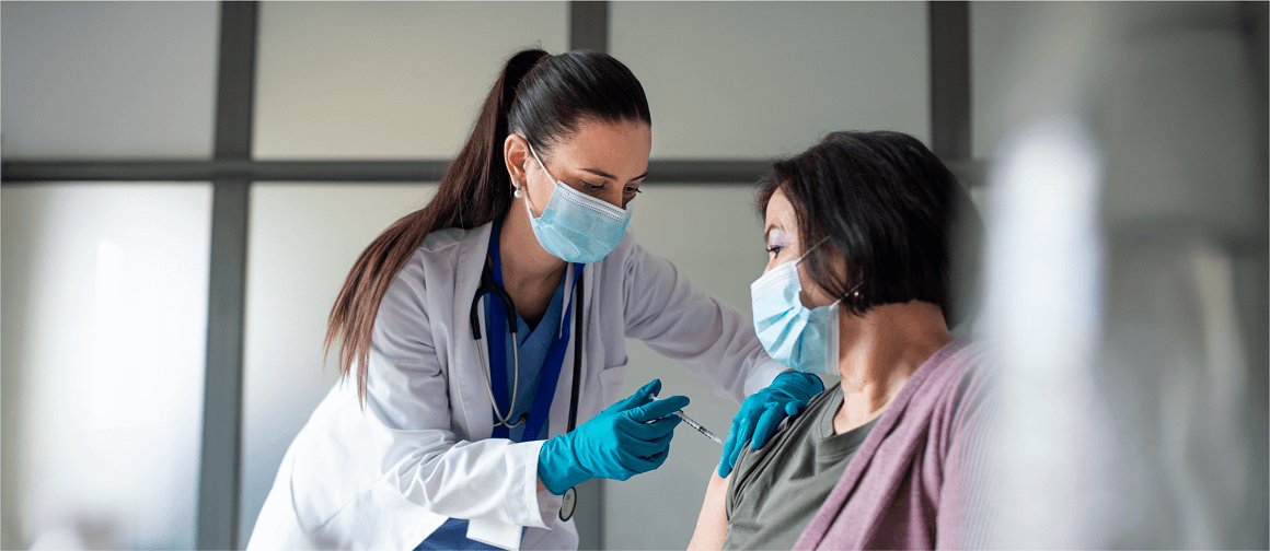 EAN21_No10_1150x500px_150ppi.png Photo of a doctor administrating vaccine to a patient.