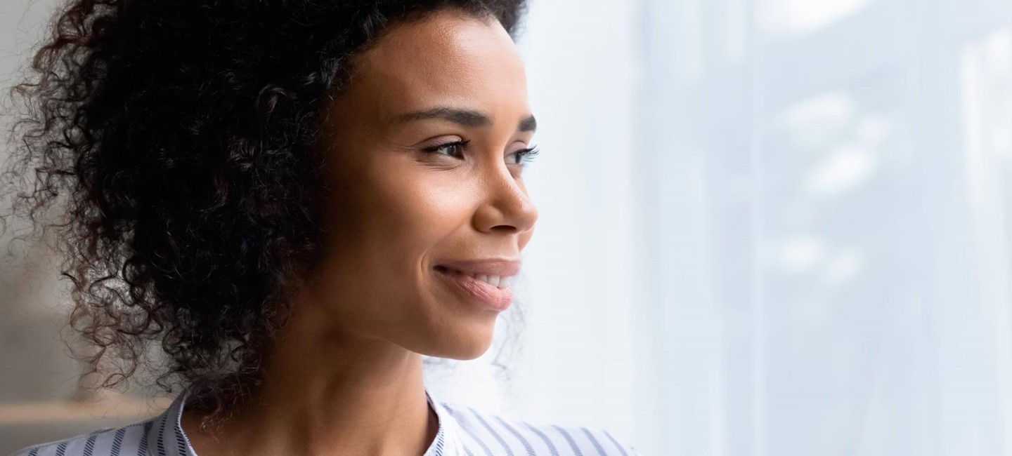 ihc-21-future-of-migraine-treatments_2320x1000.jpg Stock photo of a woman looking through a window.