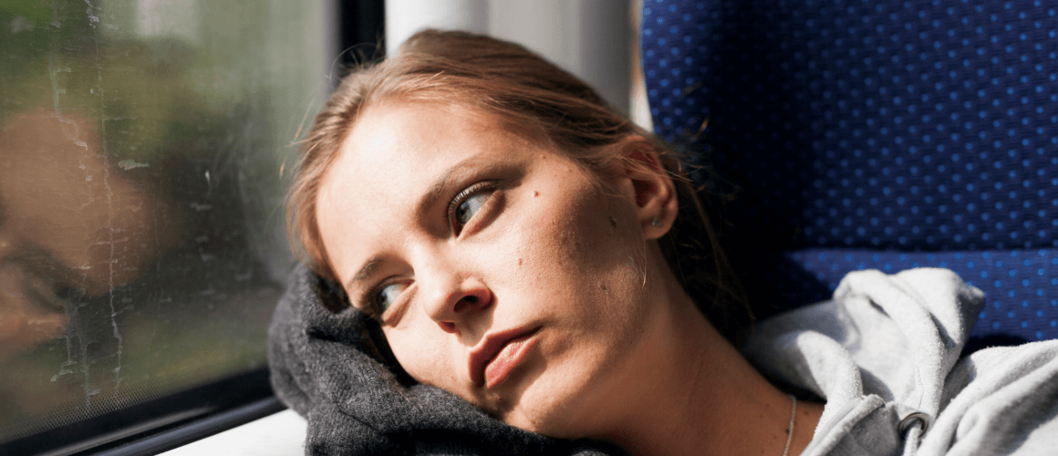MS_Classification_1160x500.PNG Woman sitting on a train, leaning her head against the window while staring outside.