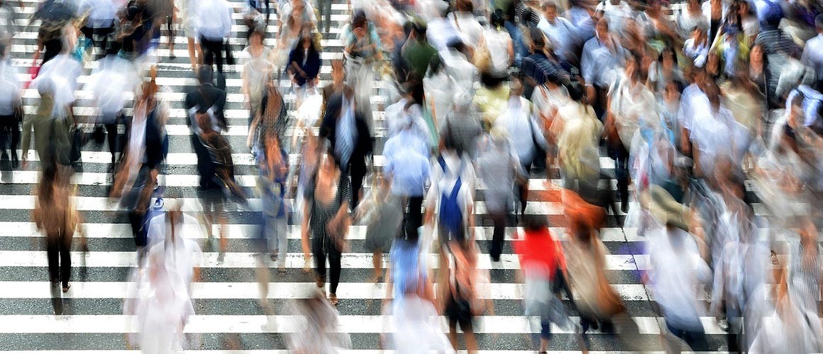 NB_Migraine_Interview_2021_Dawn-Buse-1150x500.jpg Blurry image of pedestrians crossing the road