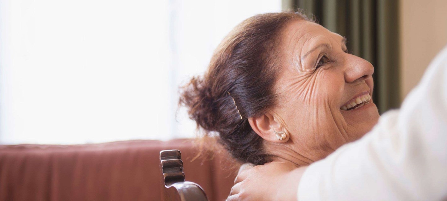 Image of a lady smiling at her carer