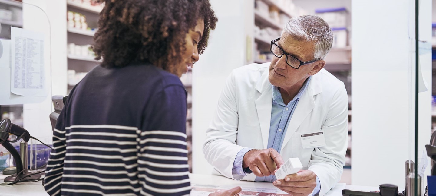 personalisedmed2320x10000.jpg a young woman speaking with male pharmacist